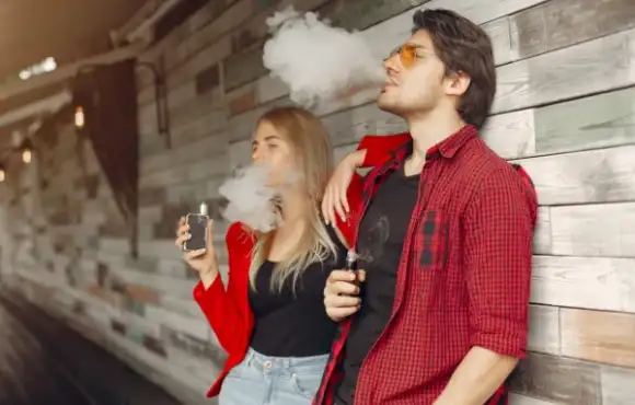 stylish-young-couple-with-vape-city-600x400